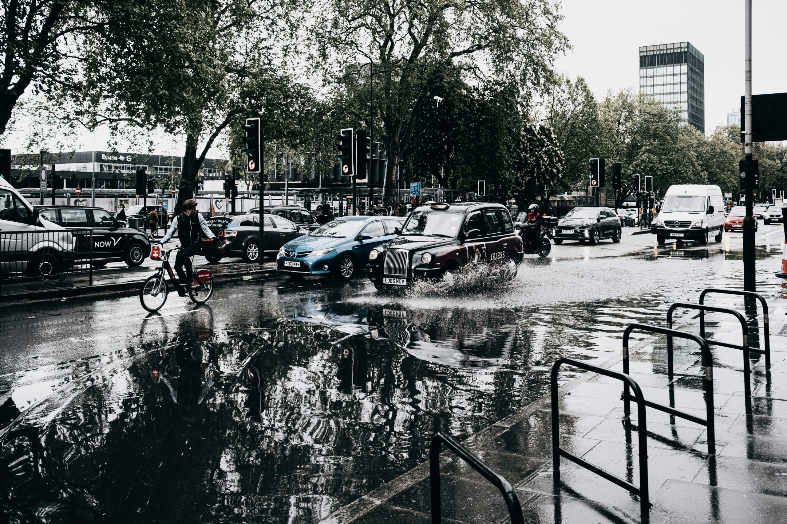 black cab in london driving through flooding